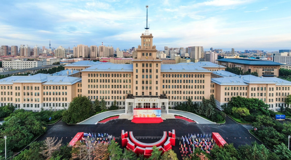 A scenic view of the grand main building of Harbin Institute of Technology during a clear day.